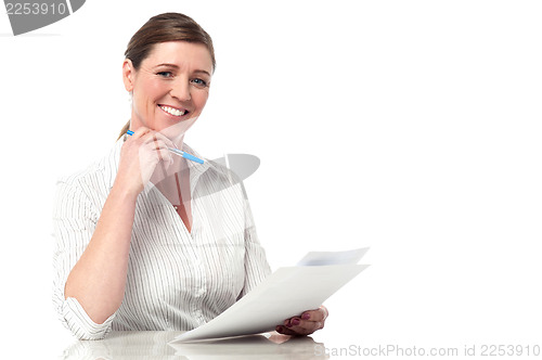 Image of Female executive analyzing business reports