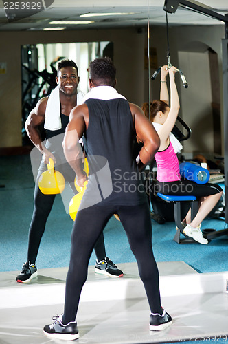Image of Fitness people working out with equipments