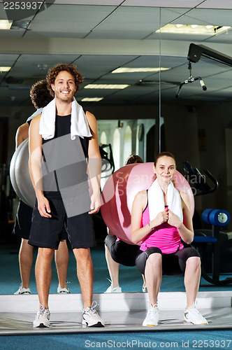 Image of Strong fit man and woman posing casually