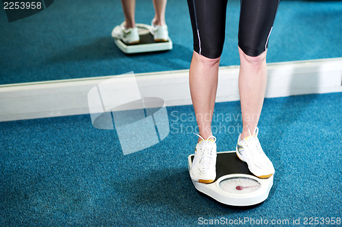 Image of Cropped image of a woman measuring weight