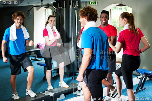 Image of Couple with personal fitness trainer in the gym