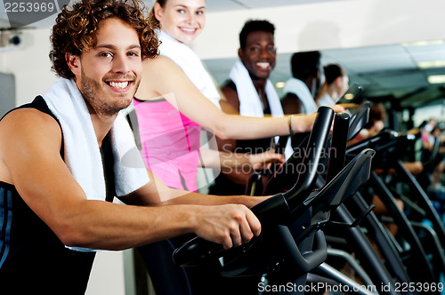 Image of People at gym working out happily