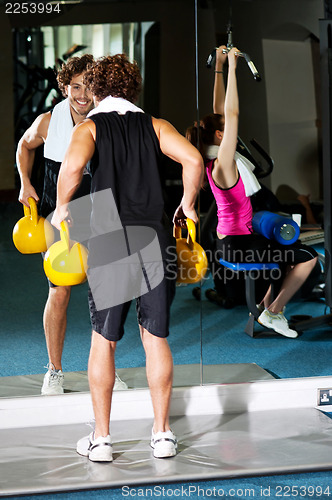 Image of Athletic people working out with equipments