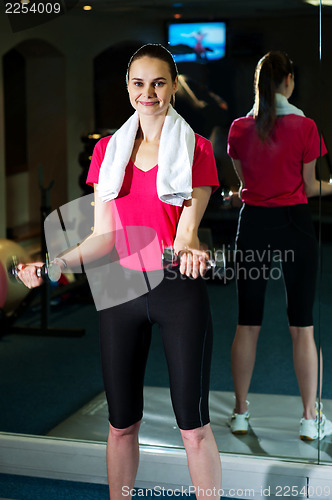 Image of Fitness woman lifting dumbbells