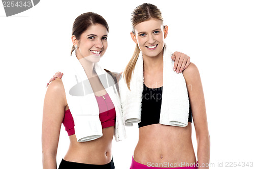 Image of Attractive fitness girls posing casually