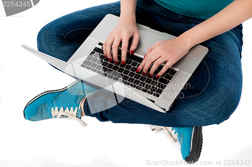 Image of Cropped image of a girl working on laptop