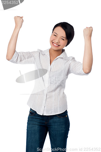 Image of Excited charming girl with clenched fists