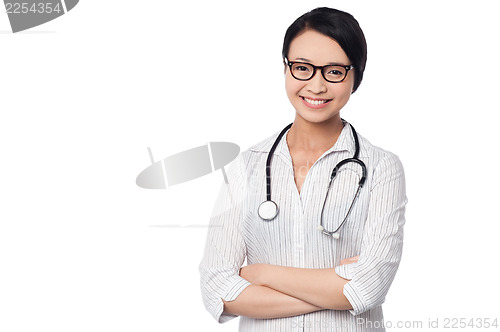 Image of Young pretty female doctor with arms folded