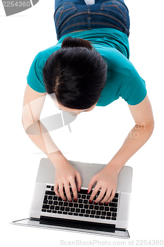 Image of Aerial shot of a girl working on laptop