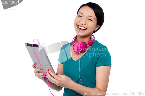Image of Girl laughing out loud while watching funny video