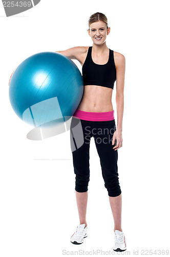 Image of Female fitness trainer holding aerobic ball