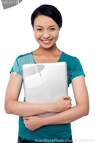 Image of Smiling asian female posing with laptop