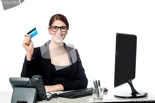 Image of Attractive businesswoman holding credit card