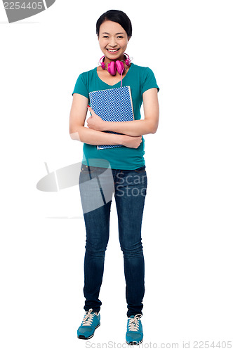 Image of College girl with headphones around her neck