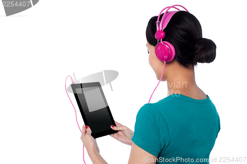 Image of Young girl enjoying music