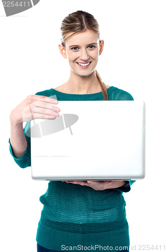 Image of Young smiling girl holding laptop