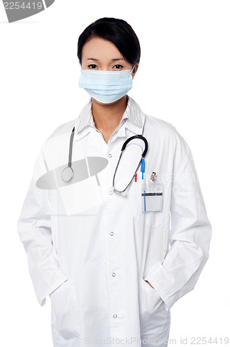 Image of Female surgeon posing with hands in lab coat