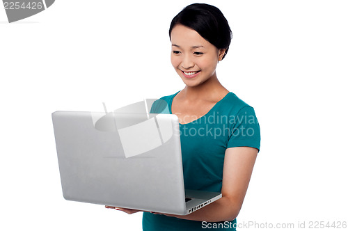 Image of Young girl working on laptop