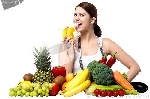 Image of Healthy caucasian girl eating banana