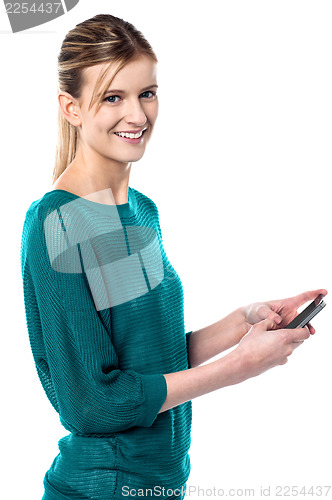 Image of Girl sending text message through cellphone