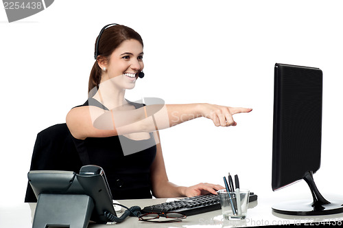 Image of Female executive pointing at computer screen