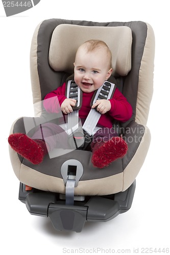 Image of child in booster seat for a car in light background