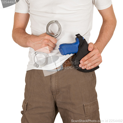 Image of Close-up of a man with holster and a gun