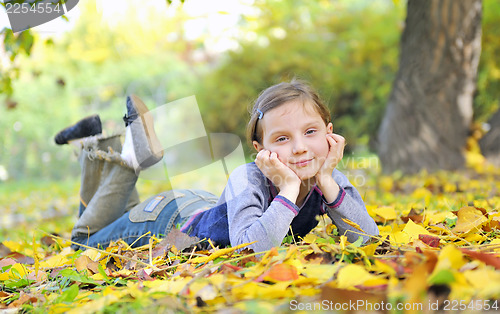 Image of little girl  laying on the grass