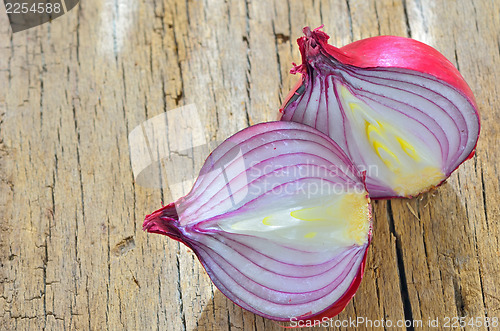 Image of Red onions isolated on wooden background