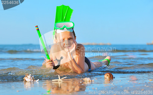 Image of boy on beach with snorkles