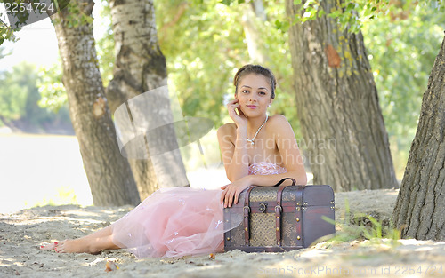 Image of beauty girl  in a old-fashioned dress in a forest 