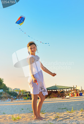 Image of Girl on beach with kite 