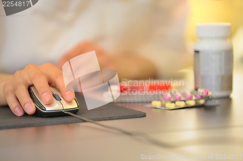 Image of hand of doctor operating mouse 