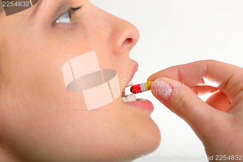 Image of Woman taking pills