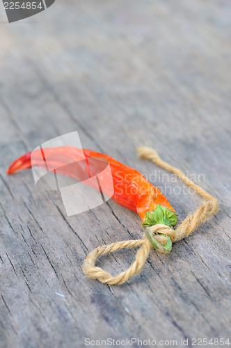 Image of Red chili peppers over wooden background 