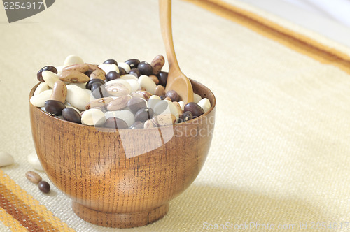 Image of colored beans in wooden bowl