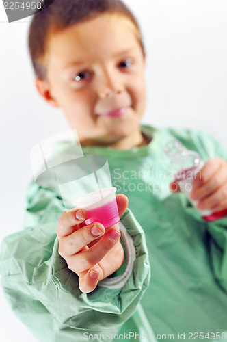 Image of little doctor boy giving syrup