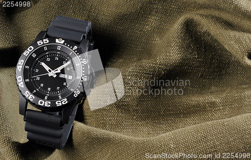 Image of military watch on sack background