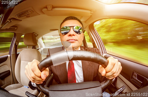 Image of Man driving a car.