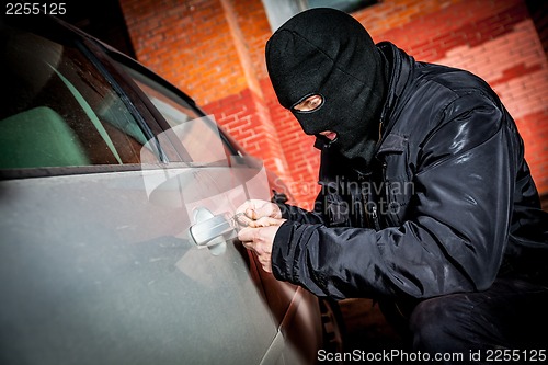 Image of Car thief in a mask.
