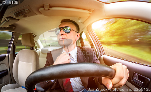 Image of Man driving a car.