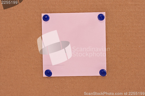 Image of Pink note paper attached with blue pins