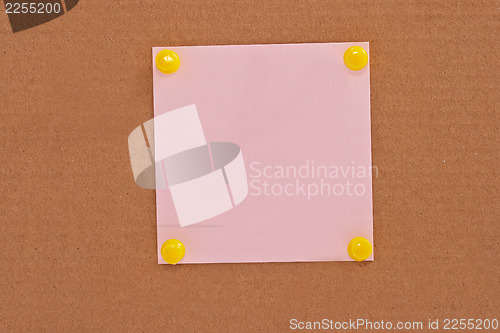 Image of Pink note paper attached with yellow pins