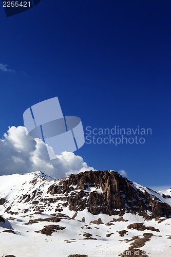 Image of Rocks in snow and blue sky