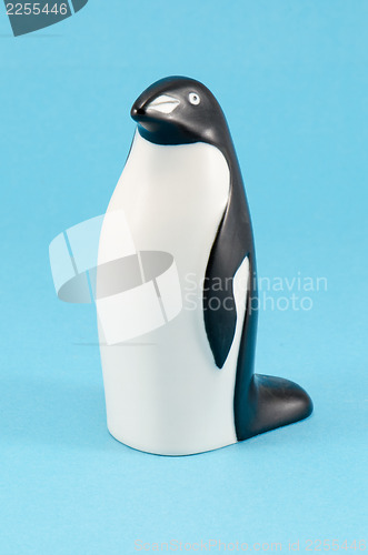 Image of toy penguin figurine home decor on blue background 