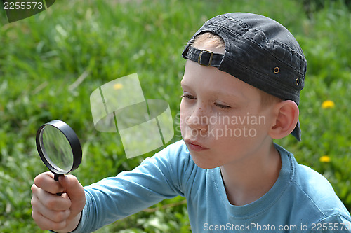 Image of the teenager with a magnifying glass