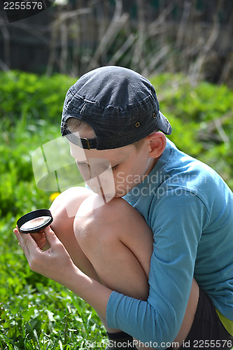 Image of the teenager with a magnifying glass