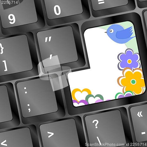 Image of bird and flowers on computer keyboard key