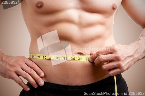 Image of Fit Man Measuring His Waist