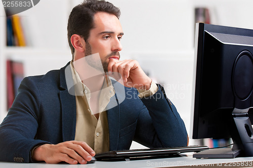 Image of Man Looking At A Computer Monitor